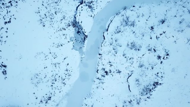 Small frozen river. Ice and snow. Aerial view landscape