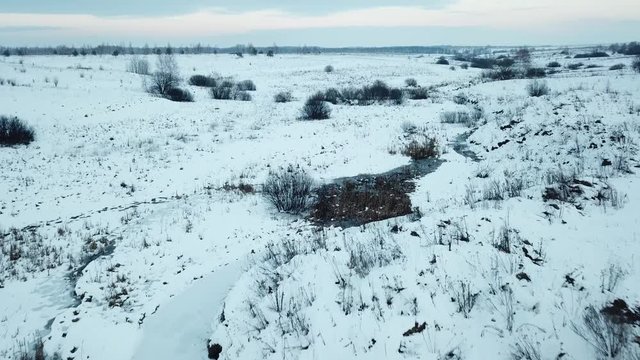 Small frozen river. Ice and snow. Aerial view landscape