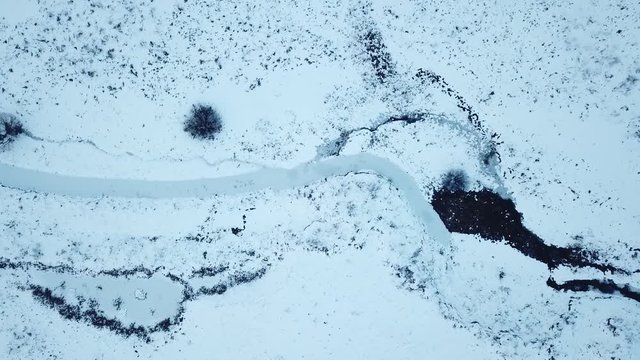 Small frozen river. Ice and snow. Aerial view landscape