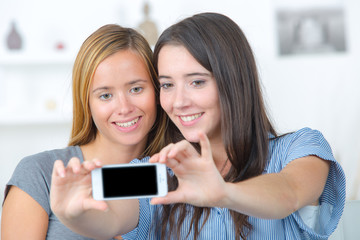 teenage girls taking selfie