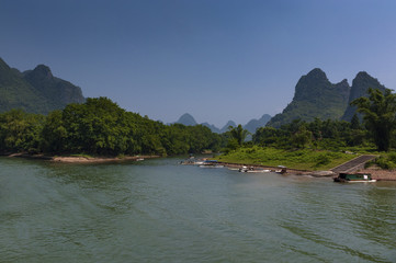 View of the Li River with the tall limestone peaks on the background near Yangshuo, China, Asia; Concept for travel in China