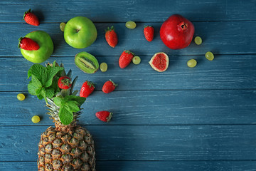 Composition with different fruits on wooden background