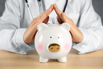 Doctor with piggy bank. Health insurance concept