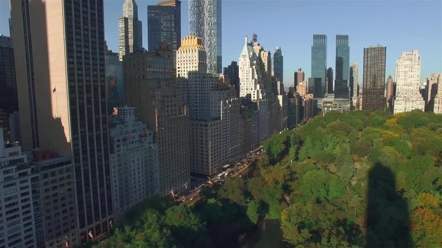 Aerial real time shot, camera is flying above Central Park along West 95th Street in New York City. The concept of Green zone in modern city such as NYC.