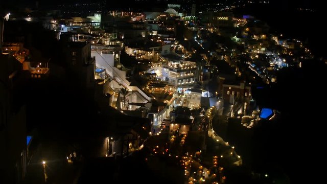 SANTORINI, GREECE – AUGUST 2016 : Video shot of Santorini cityscape at night with iconic white buildings and people in view