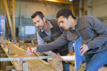 carpenter with apprentice in training period
