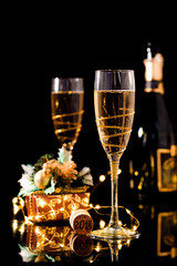 Two glasses of champagne over blur spots lights background. Celebration concept, free space for text