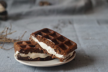 Chocolate Viennese waffles from the bran and rice flour with tender praline whipped cream and custard.