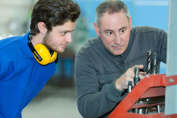 Fototapeta na wymiar apprentice in workshop factory with teacher