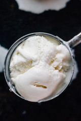 Ice cream starting to melt in metal ice cream scoop.
