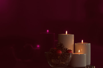 A new year decoration with magenta color reflections of candlelight on the glossy surface