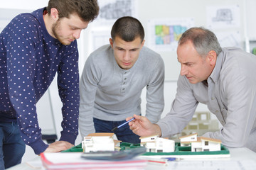 Architects looking at scale model of housing development