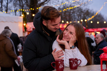 Young happy couple at Christmas market