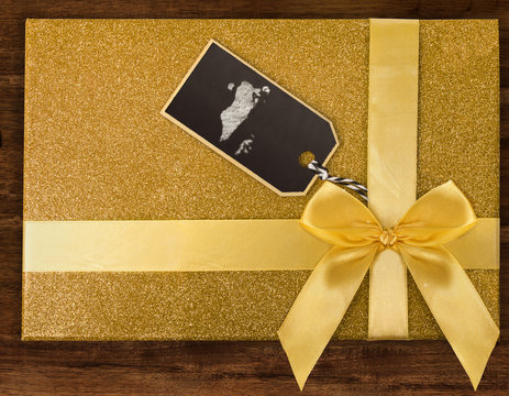 A gift box with Bahrain drawn on a label with chalk.(series)