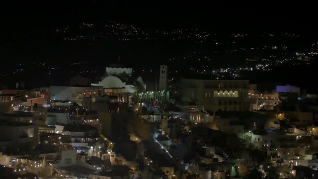 SANTORINI, GREECE – AUGUST 2016 : Video shot of Santorini cityscape at night with iconic white buildings and people in view