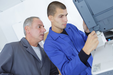 technician and apprentice stand in industry