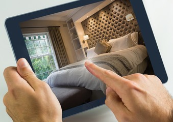 Hand touching tablet with accomodation hotel bedroom - obrazy, fototapety, plakaty