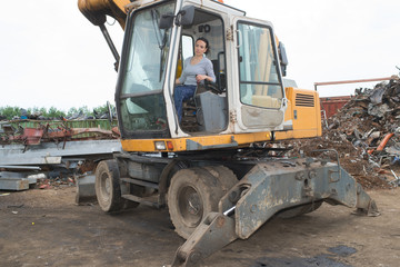 female driver in her truck in landfill