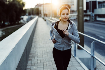 Fit woman jogging in city