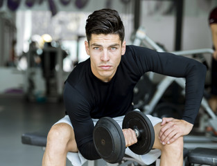 Fototapeta na wymiar Young man training in a gym