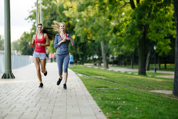 Two women jogging in park