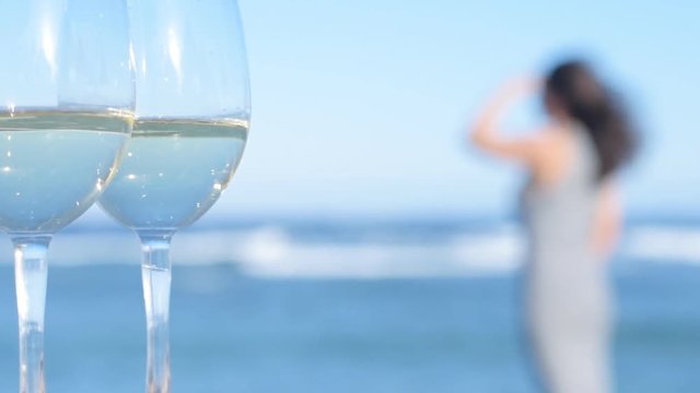 Two white wine wineglasses over sea background.Tropical vacation on beach.