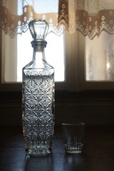 a bottle of vodka and a glass on the table