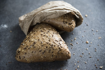 grain bread on a dark background and crumbs 