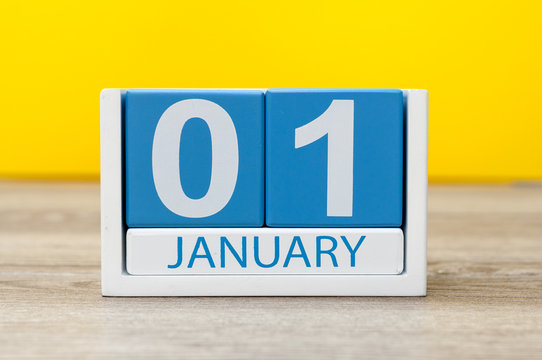 January 1st. Day 1 of january month, calendar on yellow background. Happy New year, Winter time