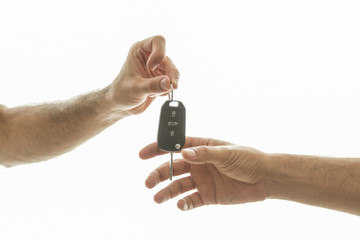 Hand of business man gives the car key with isolated on white 