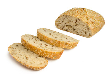 Sesame bread with different seeds and sliced isolated on white background