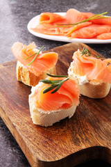 Bread with smoked salmon and cream cheese and herbs.