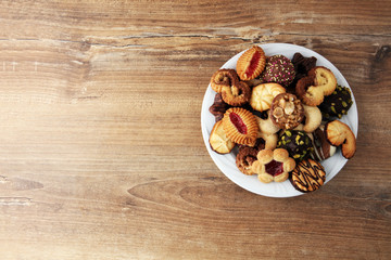 Plate with tasty fresh Christmas cookies on  table