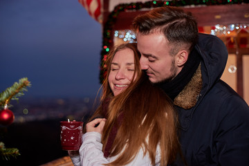 Young happy couple at Christmas market