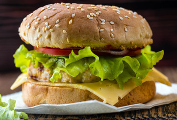 Hamburger on a napkin and on a wooden board