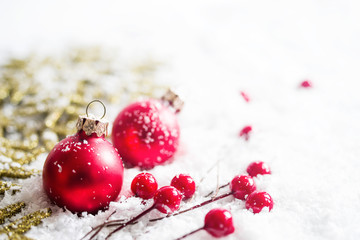 Christmas decoration, fir-tree glass balls, holidays, new year and decor concept. Closeup New Year's fir-tree toys on a snow surface, soft focus