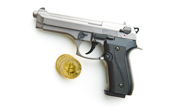 Golden bitcoins. Cryptocurrency and handgun.