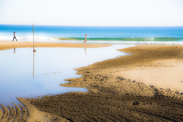 View of the beach of San Juan in Alicante, Spain in  a sunny and calm morning of winter without clouds and with temperate temperature and peaceful and relaxing atmosphere