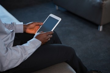 Male executive using digital tablet