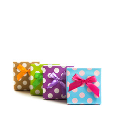 Group of gifts from multi-colored boxes with ribbons on white background