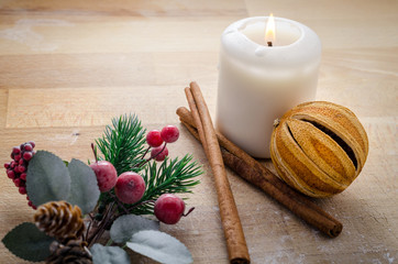 Happy Christmas, still life of few symbols of christmas. tangerine, cinnamon, candle.