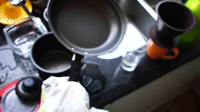 POV of Woman drying dishes with towel