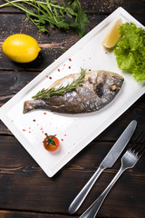  fried fish with lemon on a wooden background top view
