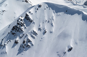 Snow cornice in winter mountains in cold sun day © BSANI