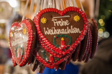 Several gingerbread hearts with Merry Christmas in German at a Christmas market