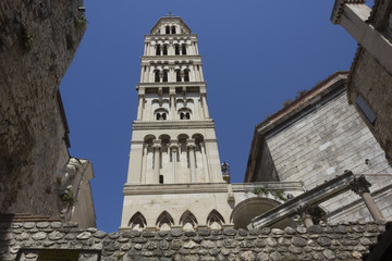 Fototapeta premium Looking up at Saint Domnius bell tower in Split, with Split fortified walls around