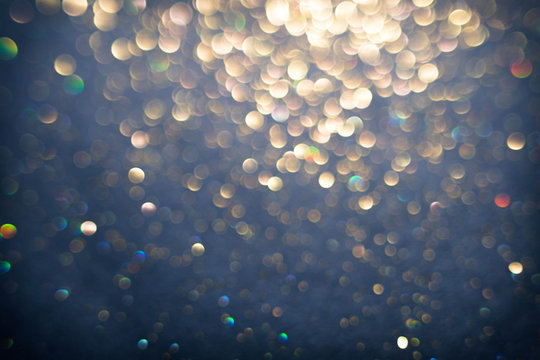 Golden and silver glitter backgound with bokeh abstract effect