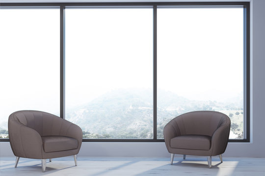 Two armchairs in a panoramic window room