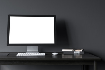 Blank computer screen in a black room