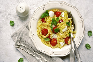 Pasta caprese with tomato,mozzarella and basil.Top view.